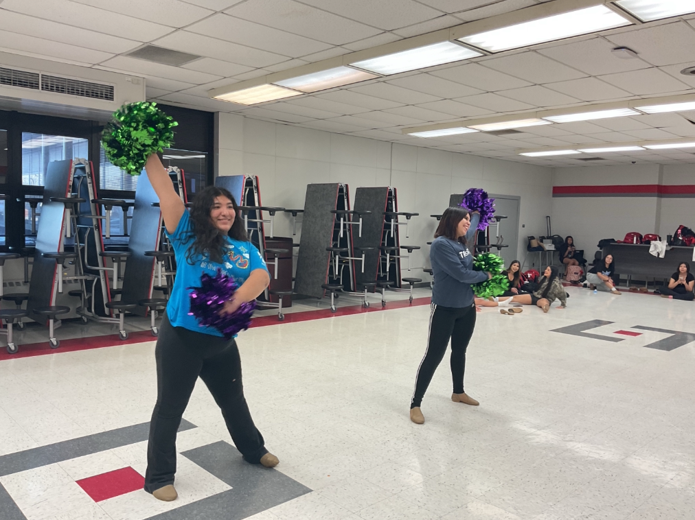 Leah Castro and Angela Trejo warm up to get ready for competition practice on Jan. 14 in the Bremen cafeteria.